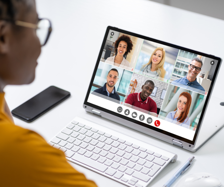 Image of a female teacher talking with students online on a laptop in a virtual meeting