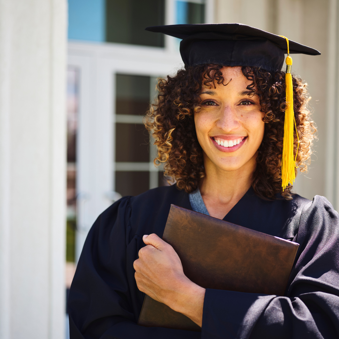 a photo of a female in a graduation cap and gown holding a diploma. 